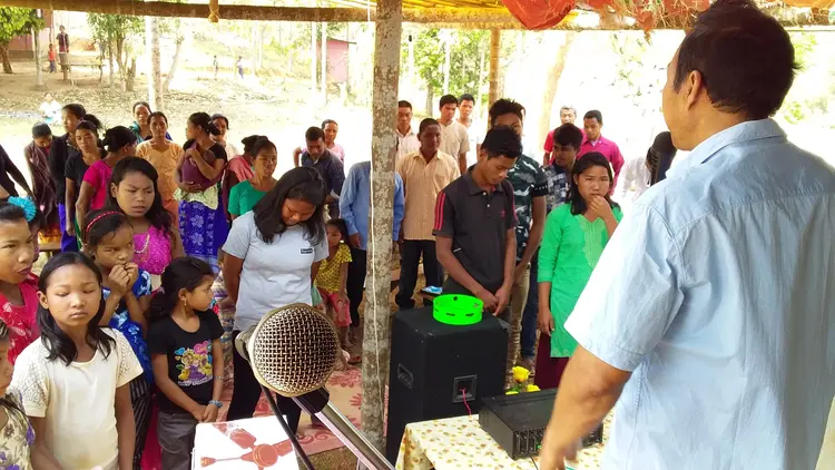 Mr. Sunmith G. Momin praying over the Students at Rongmasu Mission Field.